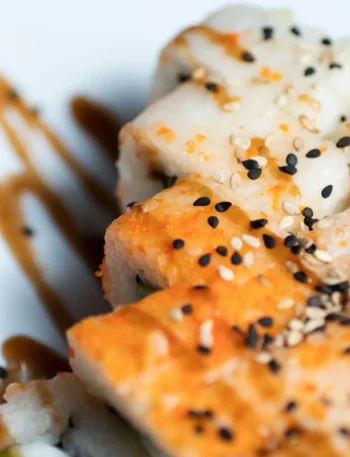 Hamachi collar recipe with soy sauce, sake, and mirin, served with sesame seeds and scallions