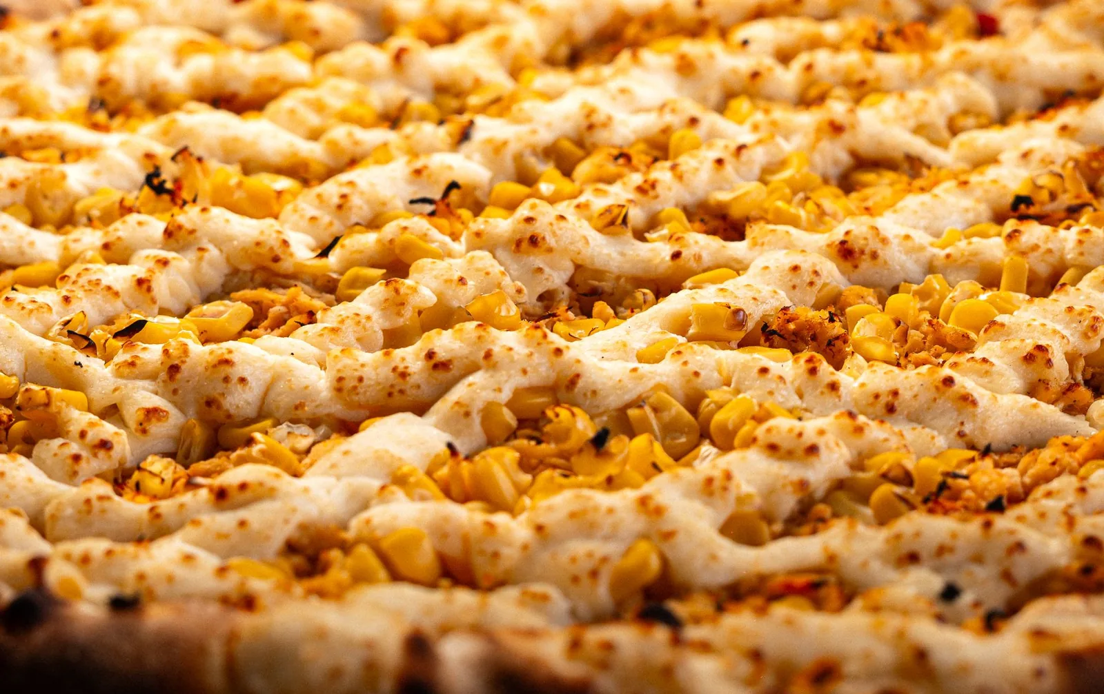 No egg cornbread recipe with a golden crust and moist interior, topped with melted butter and a sprinkle of corn kernels