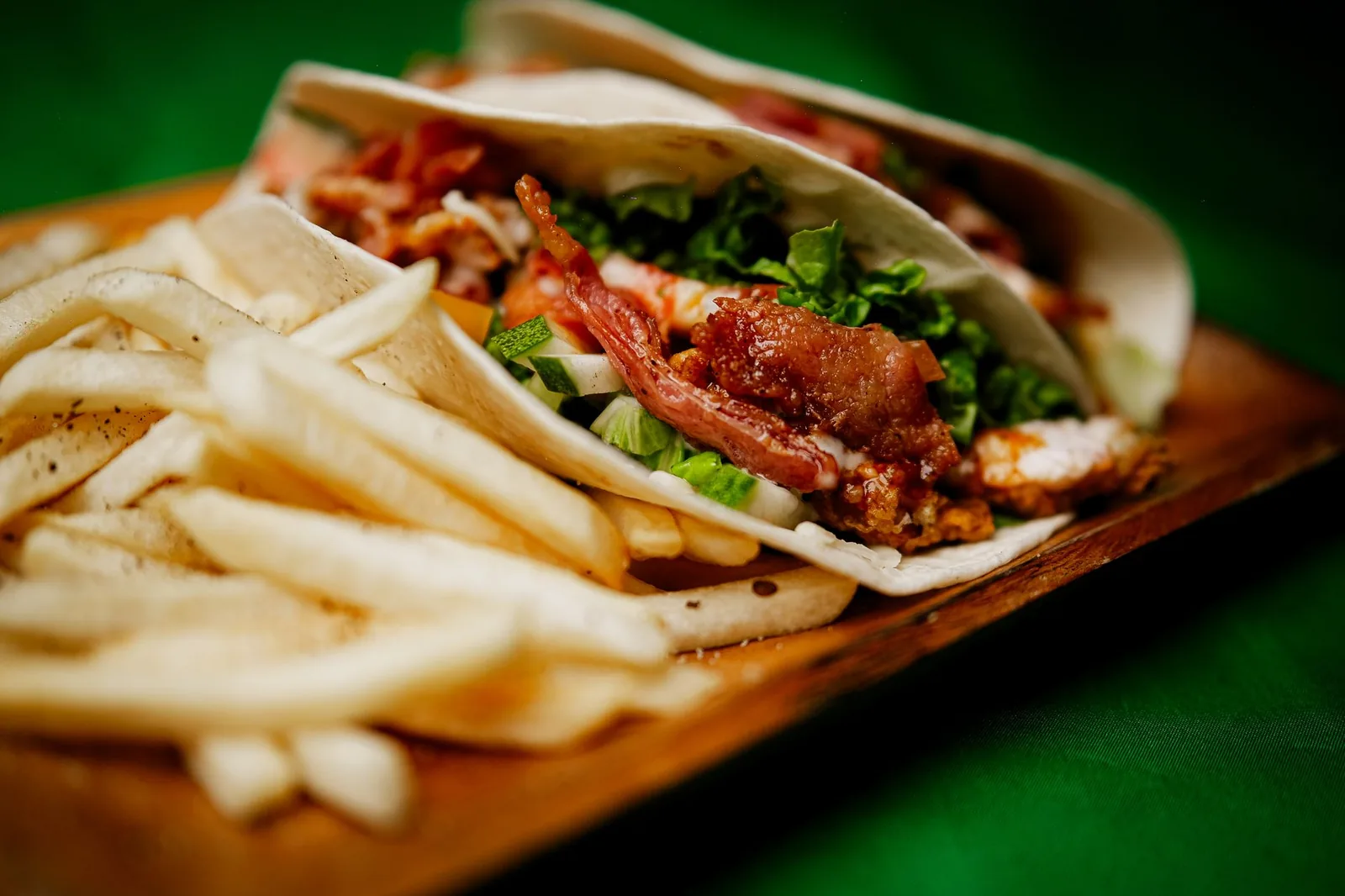 plate of buffalo chicken tacos with cabbage slaw and warm tortillas