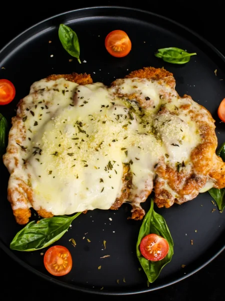 30 minute chicken parmesan recipe with golden breaded chicken cutlets, red marinara, and melted mozzarella on a sheet pan