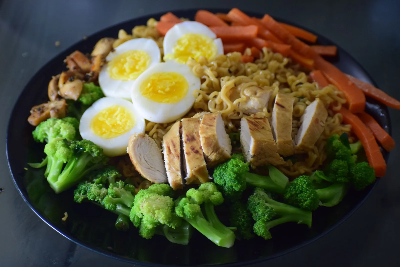 skillet of honey soy chicken noodles with broccoli and cheddar for family dinner