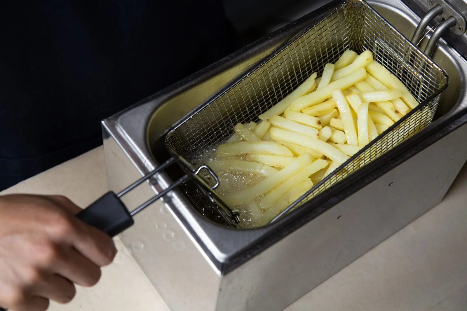 air fryer frozen seasoned fries in basket golden crisp
