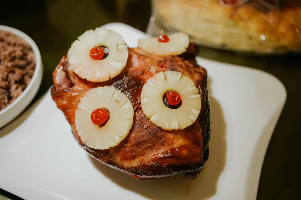 air fryer ham with bourbon glaze showing a spiral ham slice with glossy mahogany bourbon glaze and crisp edges on a white platter