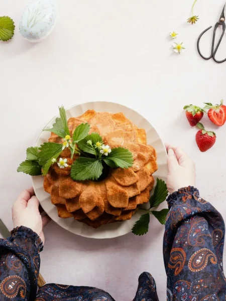 angel food cake recipe from scratch shown as a tall golden tube cake with a soft open crumb and fresh strawberries on top