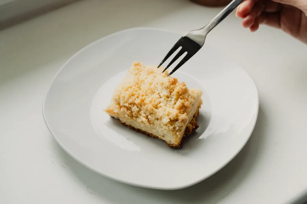 baked orange roughy recipe with lemon zest and golden breadcrumb herb topping on a white plate