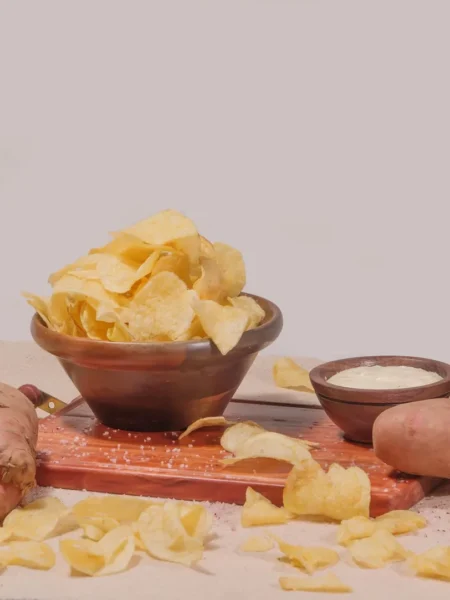 baked sweet potato chips recipe with thin orange rounds seasoned with smoked paprika on a parchment lined tray