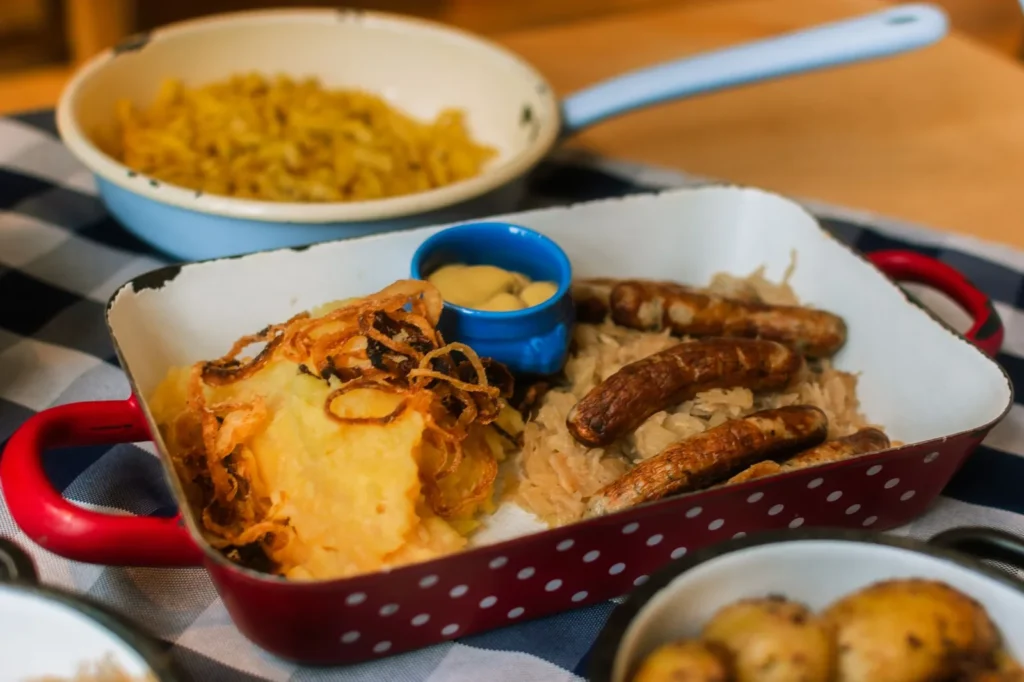 best air fryer brats recipe with golden crisp pork bratwurst in toasted buns topped with sauerkraut and mustard