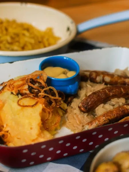 best air fryer brats recipe with golden crisp pork bratwurst in toasted buns topped with sauerkraut and mustard