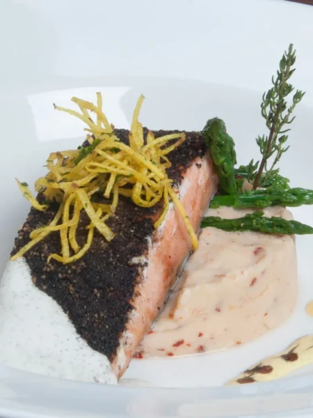 blackened mahi mahi recipe with dark spice crust, flaky white interior, and lemon wedges on a cast iron skillet
