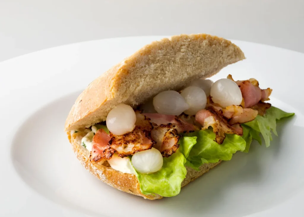 blt sandwich recipe with avocado on toasted bread with crisp bacon, tomato, lettuce, and mashed avocado spread