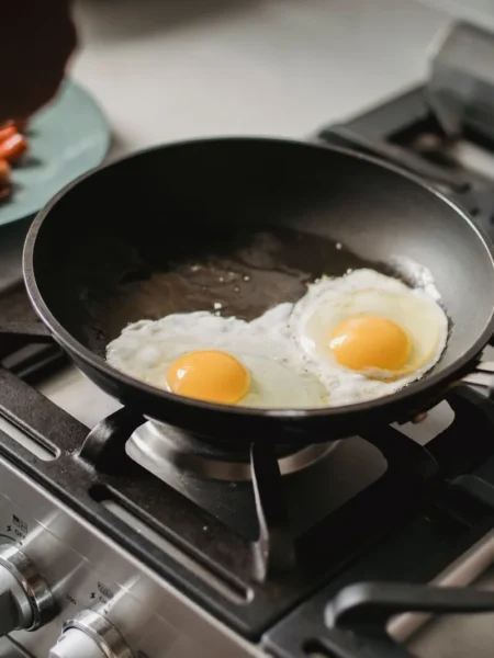 breakfast skillet recipe with potatoes and sausage showing golden potato cubes, browned sausage rounds, and soft eggs in a cast iron pan