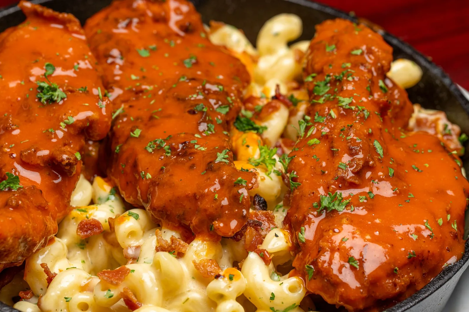 skillet of buffalo chicken pasta with creamy orange sauce and blue cheese