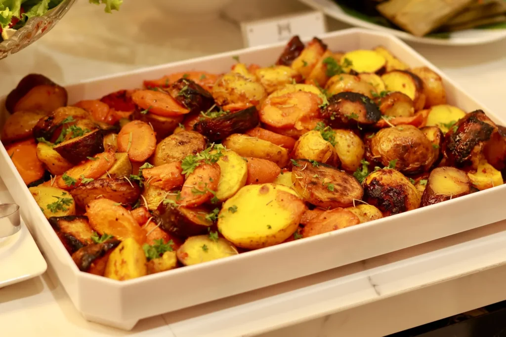 carrots and parsnips recipe with golden roasted batons on a lined baking tray