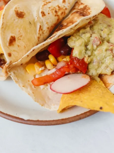 cheesy gordita crunch recipe with a crispy corn shell sealed to a soft flour tortilla by melted cheddar and filled with beef lettuce and sour cream
