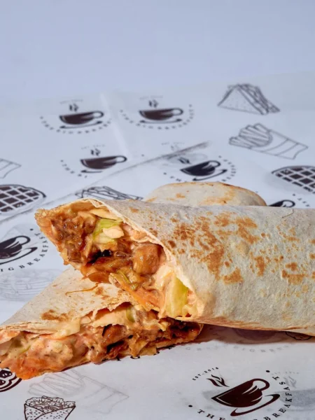 chicken bacon ranch wrap recipe with crisp bacon strips, sliced chicken, and ranch on a soft tortilla