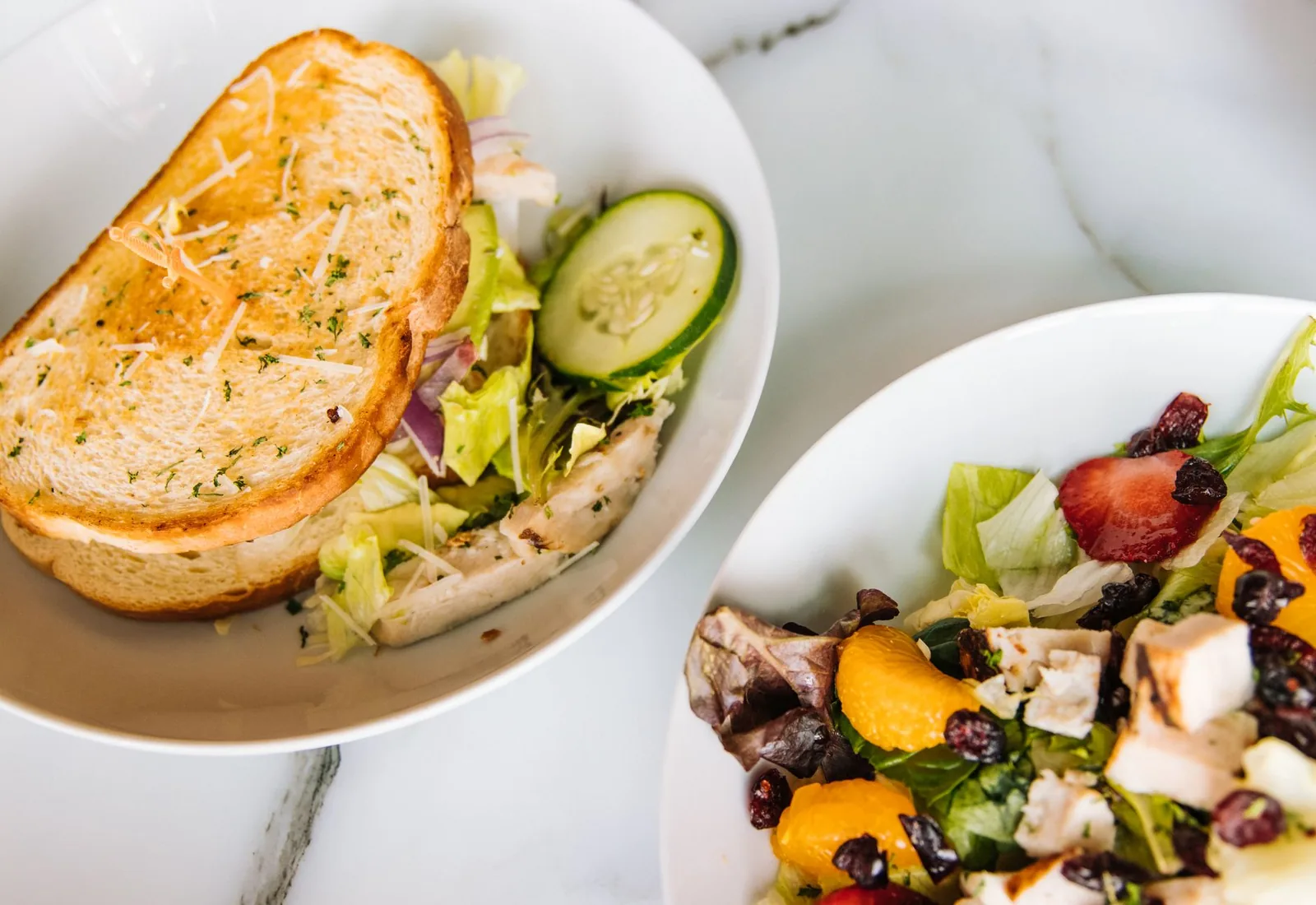 bowl of chicken strawberry salad with champagne vinaigrette and pecans