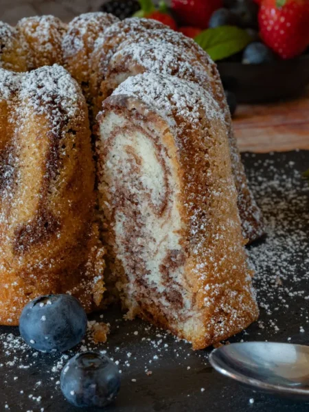 chocolate coffee marble cake recipe with swirled cocoa and espresso batter on a sliced round loaf