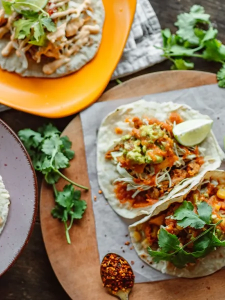 cilantro lime chicken tacos with sliced grilled thighs, red cabbage, and queso fresco in toasted corn tortillas