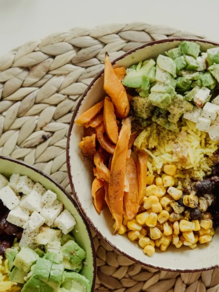 cowboy caviar bowl with black beans, corn, red pepper, and avocado in lime dressing