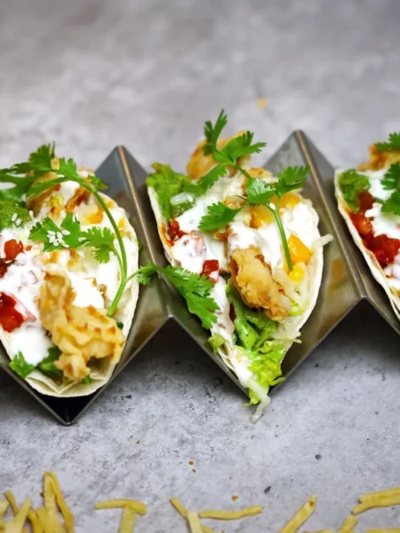 crispy fish tacos with mango salsa showing golden battered cod strips in corn tortillas topped with diced mango and cilantro
