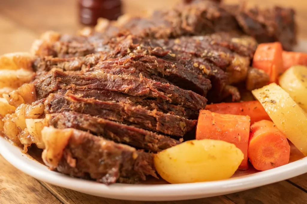 dutch oven red wine braised pot roast with fork-tender beef chuck, carrots, and parsnips in glossy red wine sauce