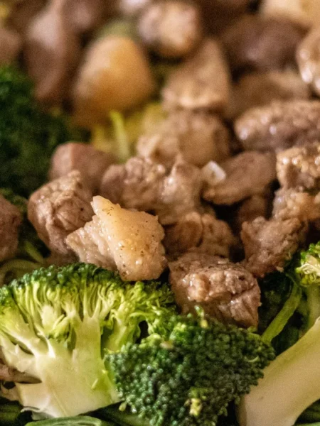 easy beef and broccoli stir fry recipe with glossy soy-garlic sauce, tender beef strips, and crisp green broccoli in a skillet