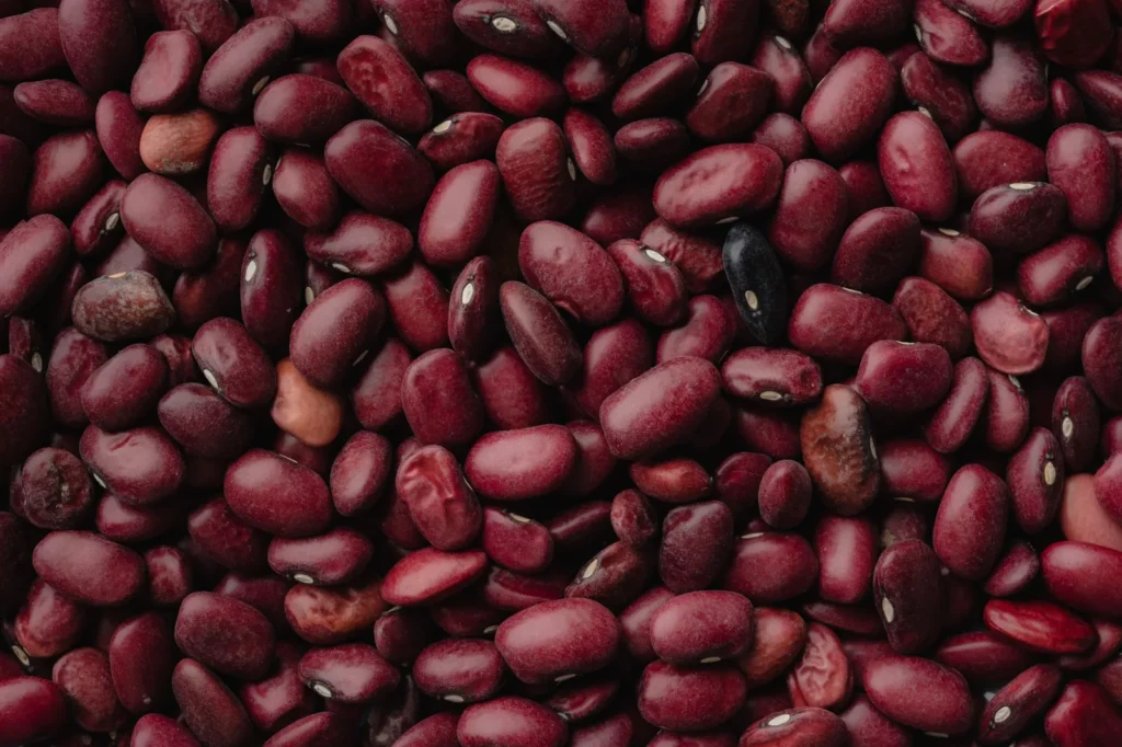 easy beef chili recipe for cold nights with ground beef, red kidney beans, and black beans in a steaming pot