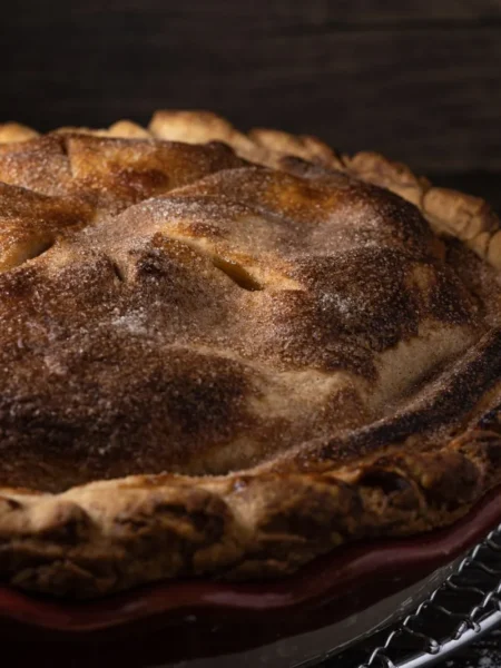 easy chicken pot pie recipe from scratch with golden flaky crust, creamy chicken pea carrot filling in a glass pie dish