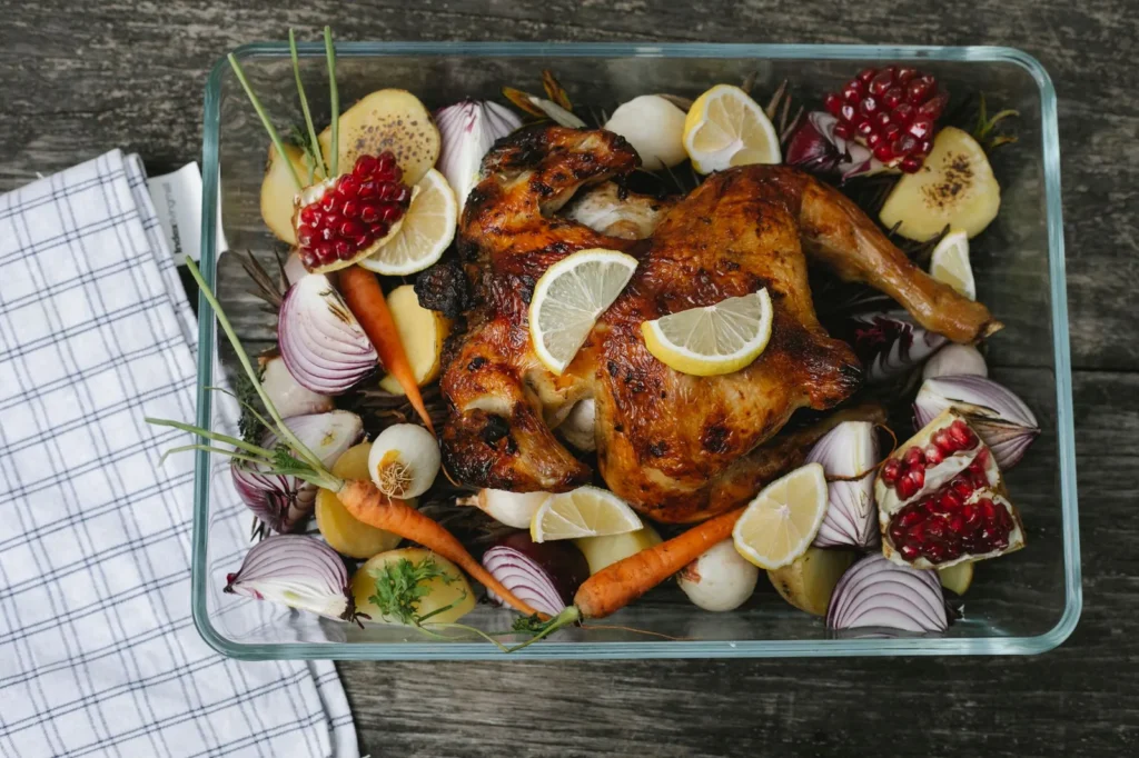 easy spatchcock chicken roasted golden with crisp skin, lemon halves, and thyme on a sheet pan
