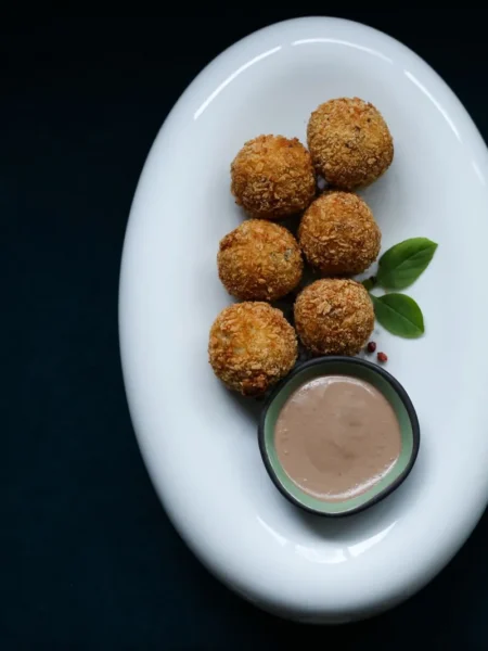 easy tuna cakes recipe with golden panko crust, flaked tuna, and green onion on a white plate