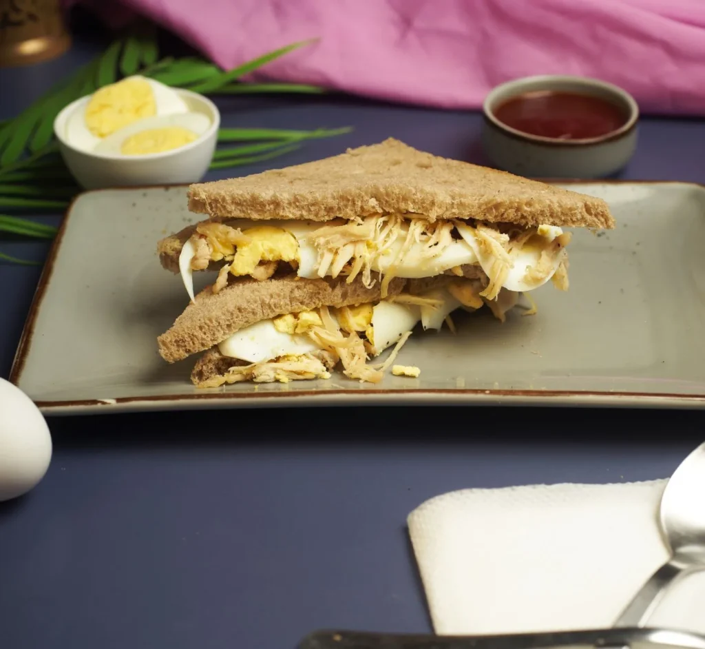 egg salad sandwich recipe classic style with chopped eggs, mayo dressing, and romaine on white bread