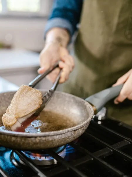 geoduck steak recipe with golden pan-seared clam steaks, butter glaze, and parsley on a wooden board