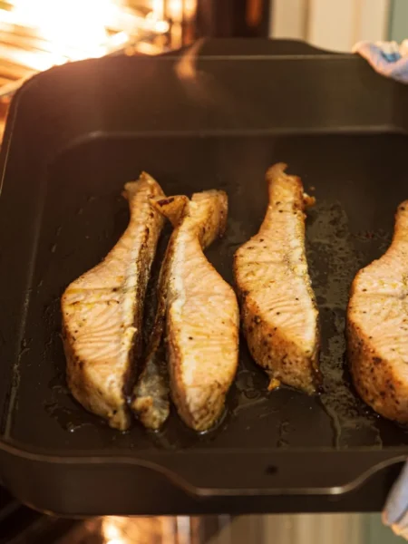 gluten free dinner recipe for celiac diet showing baked salmon fillets on turmeric rice with green beans and lemon slices
