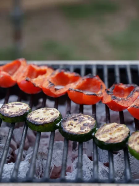 grilled zucchini roll ups filled with herbed ricotta and roasted red pepper on a white platter