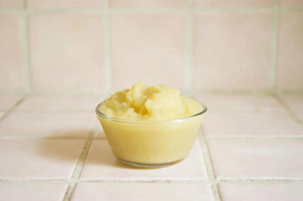 instant pot applesauce recipe homemade in a glass bowl with cinnamon speckles and soft apple texture