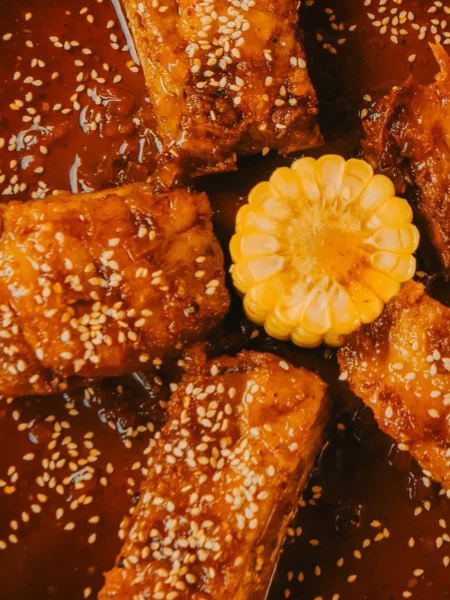 instant pot ribs recipe fall off the bone with sticky barbecue glaze on a foil tray after broiling
