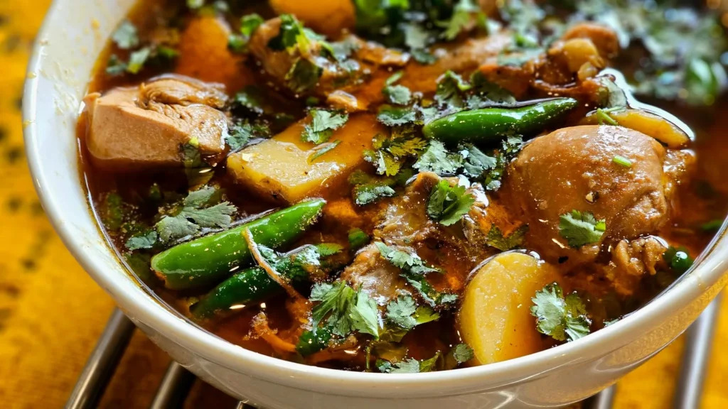 instant pot white chicken chili recipe with shredded chicken, great northern beans, and green chiles in a creamy broth topped with cilantro