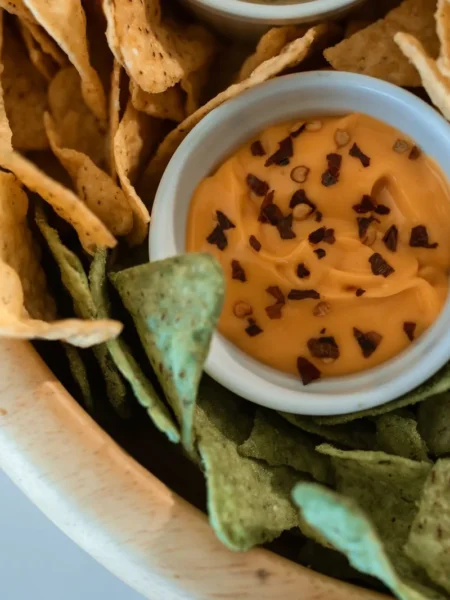 jalapeno artichoke dip baked golden in a white dish with melted cheese and jalapeno bits on top