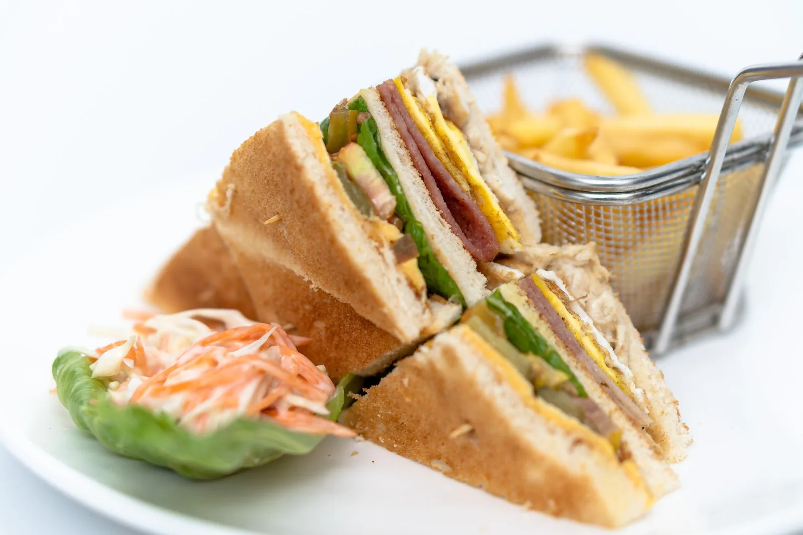 toasted ham sandwich with cheddar and cabbage slaw on plate