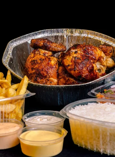 leftover rotisserie chicken lunch ideas with shredded chicken, tortilla wraps, rice bowls, avocado, and cherry tomatoes on a counter