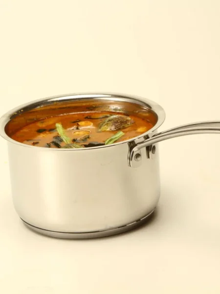 lentil veggie superfood stew in a blue pot with brown lentils, kale, and carrots in spiced broth