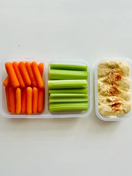 lunchbox ideas for elementary school kids with pita, cheese stick, grapes, and hummus in a divided container