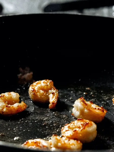 pan seared shrimp recipe with golden shrimp in garlic butter sauce in a cast iron skillet