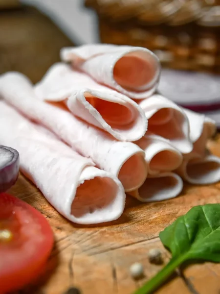 pinwheel sandwich recipe for parties with turkey, cheddar, spinach, and red pepper rolled in tortillas on a white platter
