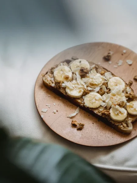 pistachio butter banana toast with sliced banana and sea salt on golden sourdough bread