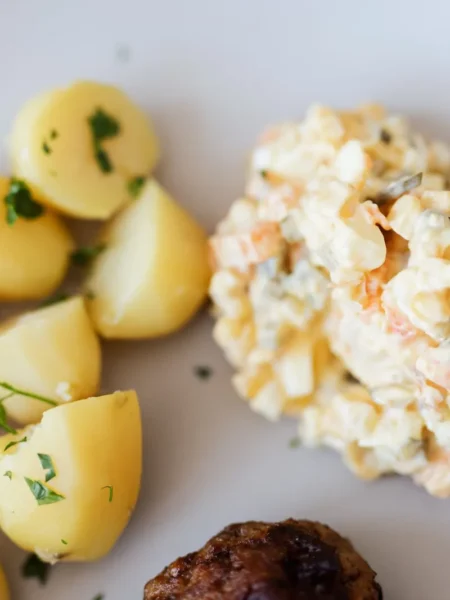 potato carrot salad 2 with boiled potato cubes, sweet carrot pieces, and creamy yogurt dressing in a white bowl