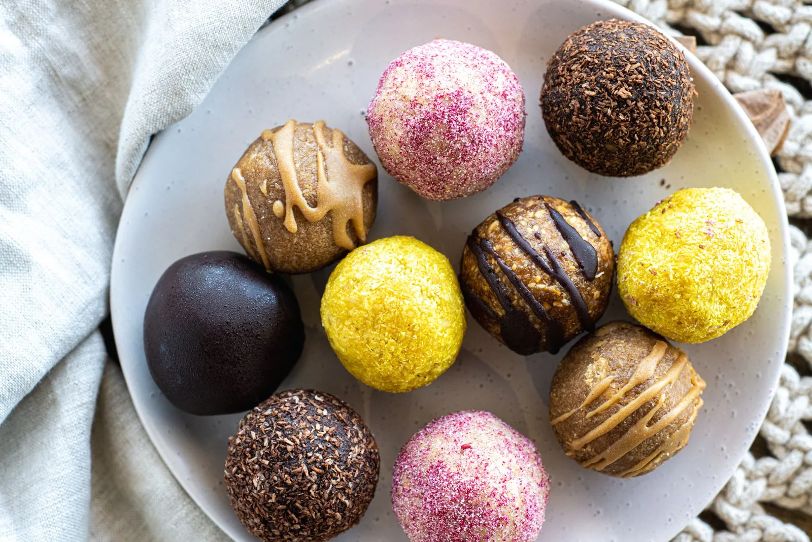 golden oat peanut butter balls with chocolate chips on white plate