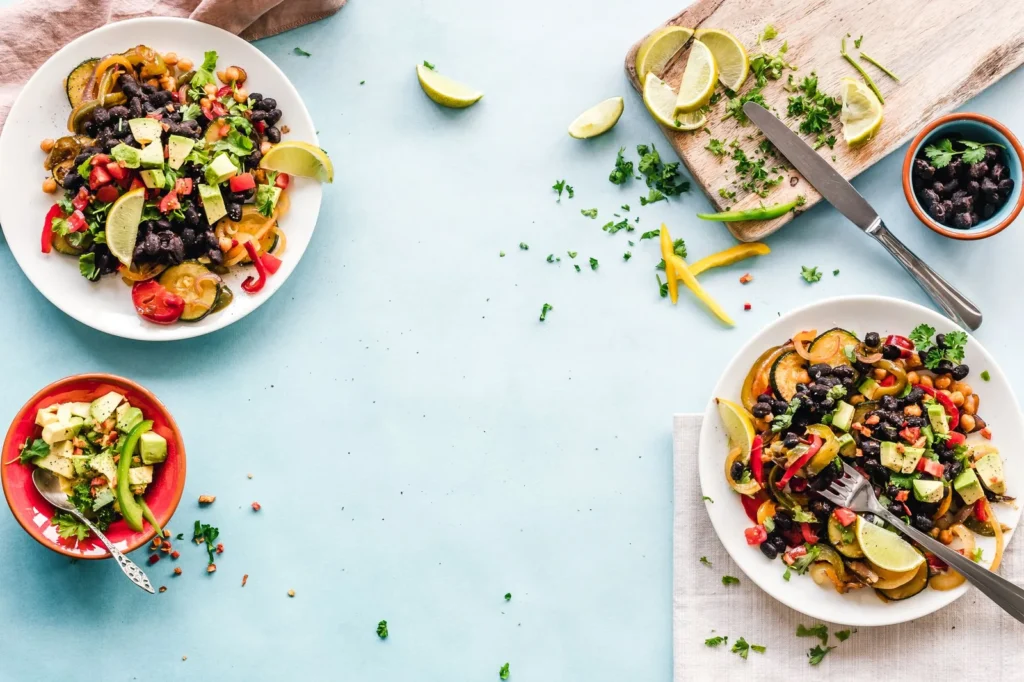 quinoa black bean salad recipe in a white bowl with red pepper, corn, and lime dressing