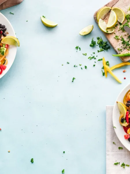 quinoa black bean salad recipe in a white bowl with red pepper, corn, and lime dressing