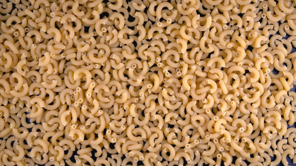 recipes using evaporated milk shown as creamy cheddar macaroni and chocolate fudge in white bowls on wood